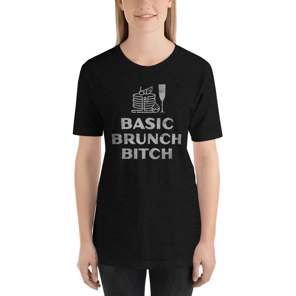 Person wearing a black heather BASIC BRUNCH BITCH tee with pancakes and a champagne flute