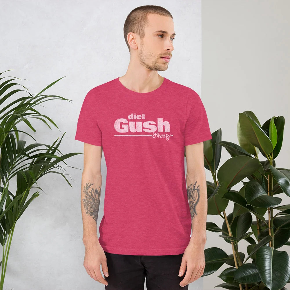 Person in the heather pink diet Gush Cherry tee standing between houseplants