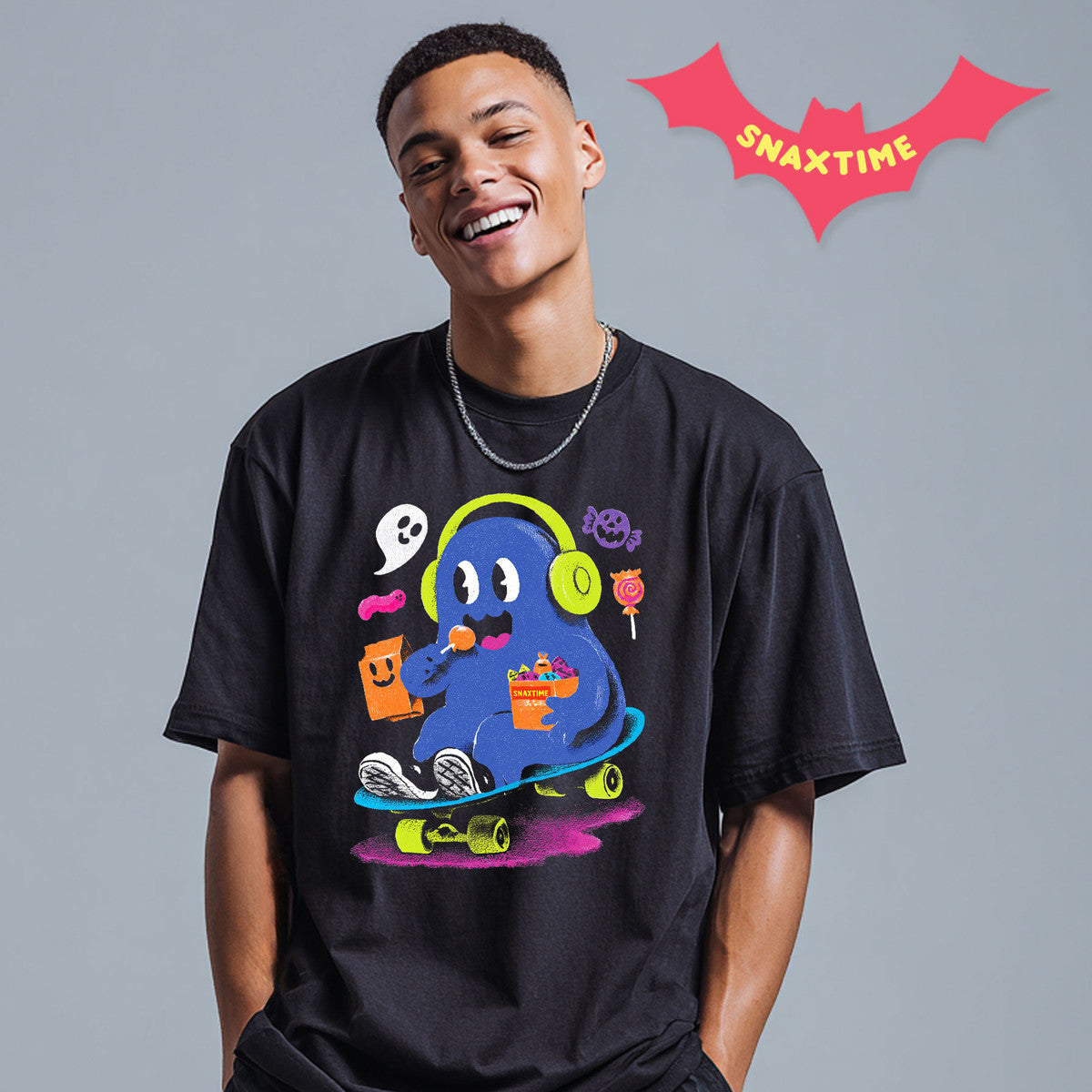 Model wearing the Skater Boo black Halloween graphic t-shirt, showing the skateboarding ghost print across the chest.