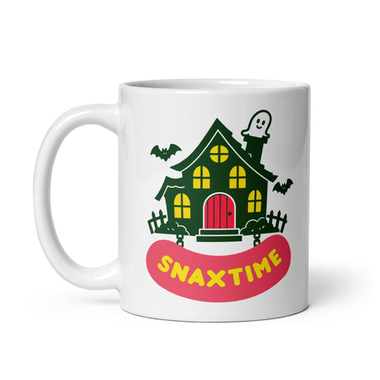 Front of a white 11 oz mug: dark green haunted house with yellow windows, a red door, bats and a smiling chimney ghost.