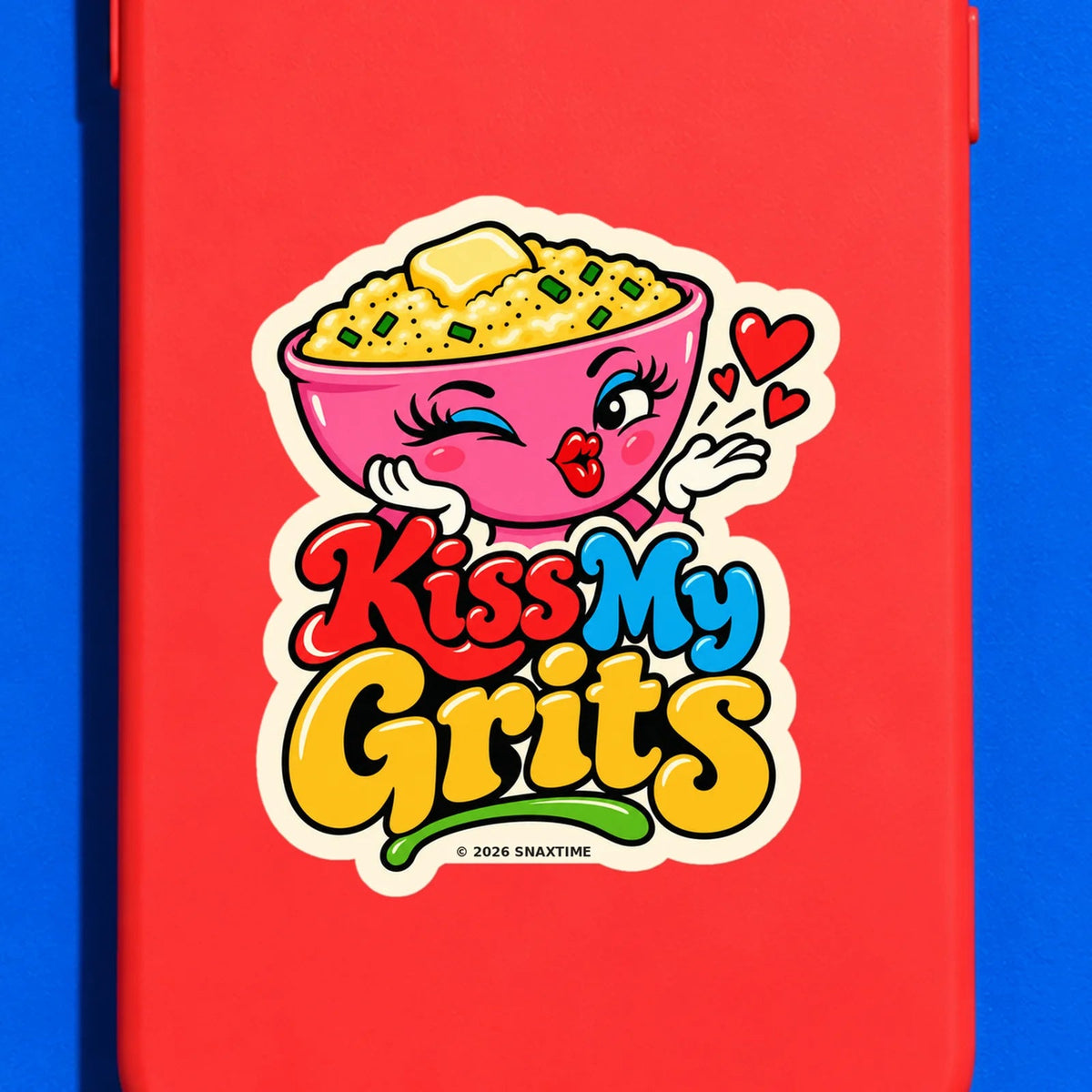 Close-up of the Snaxtime “Kiss My Grits” sticker on a phone case; part of Food Pun Sticker Sheet Set 1.