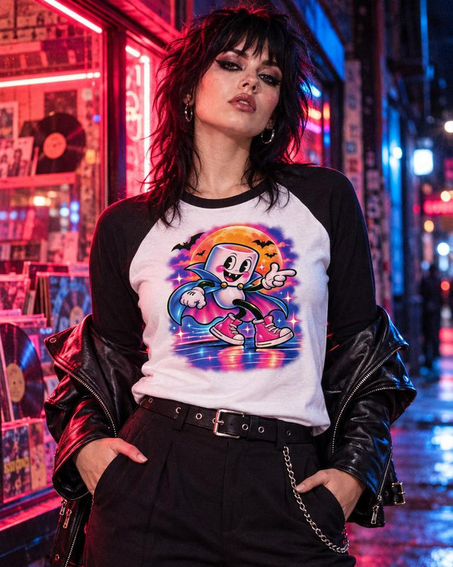 Model wearing the white and black Moonwalk Mallow vampire raglan tee outside a neon-lit record shop.