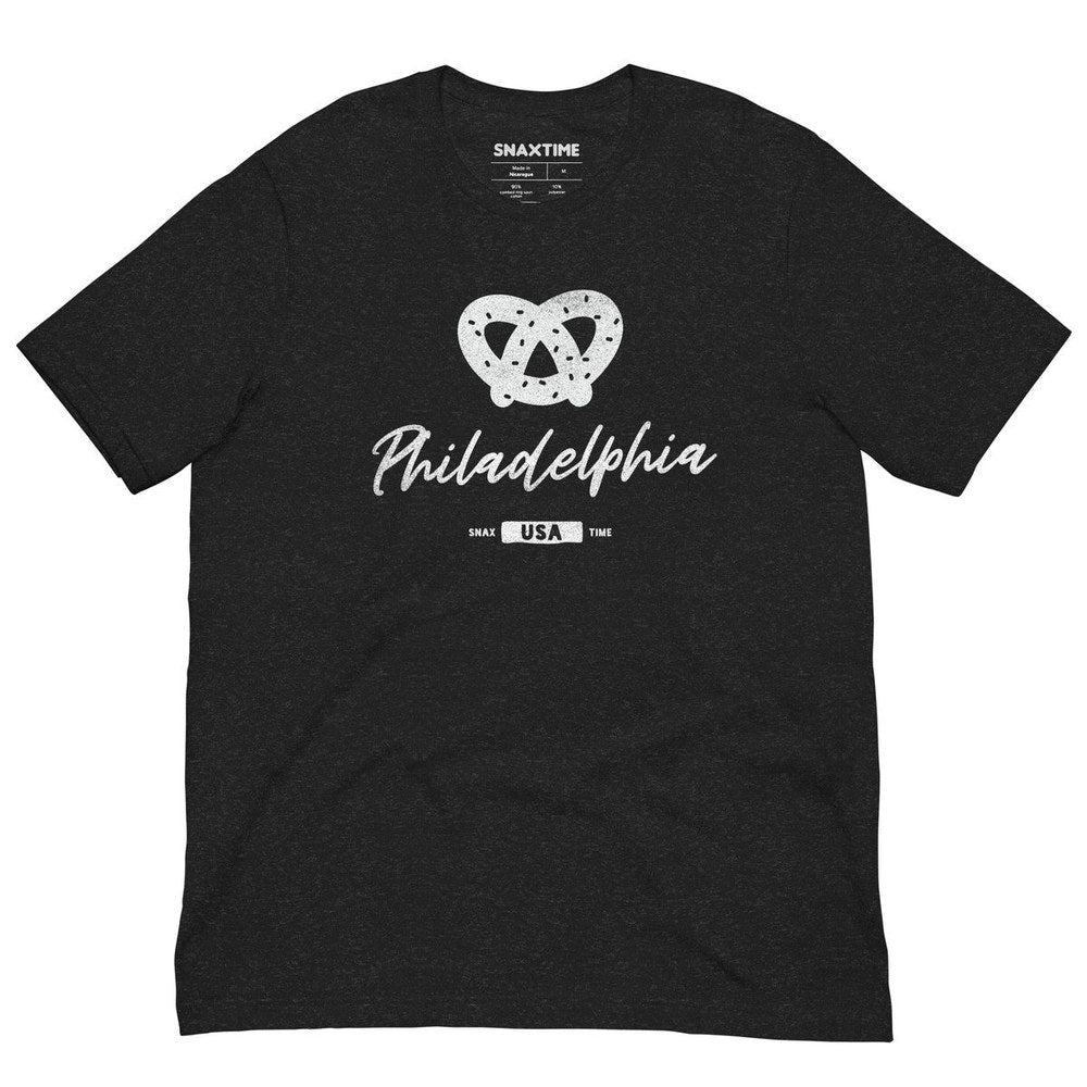Heather black t-shirt laid flat with a white soft pretzel and script "Philadelphia" print