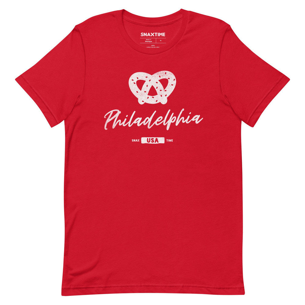 Red t-shirt with a white salted soft pretzel above script "Philadelphia" and a USA badge