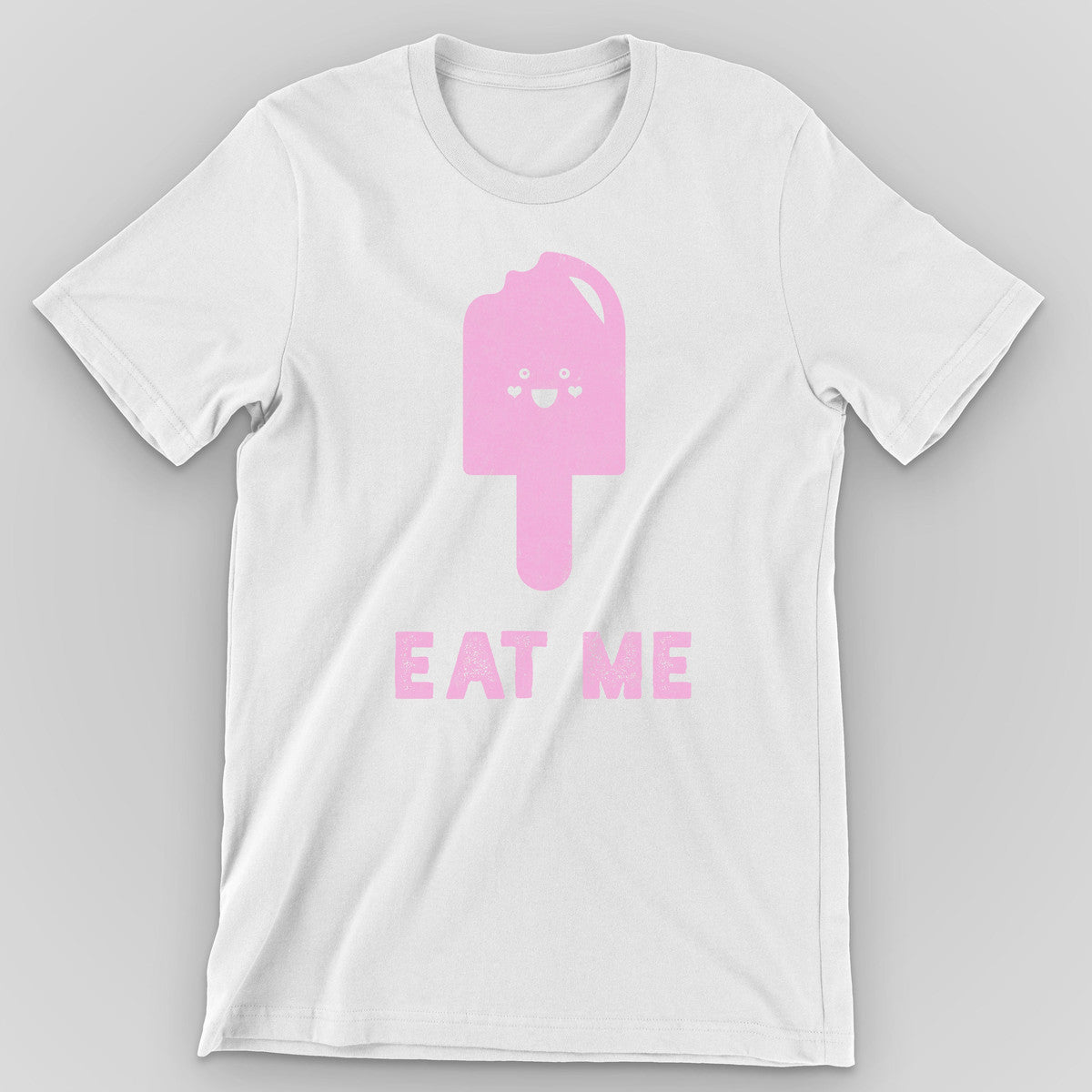 White t-shirt with a pink bitten popsicle character and 'Eat Me' below