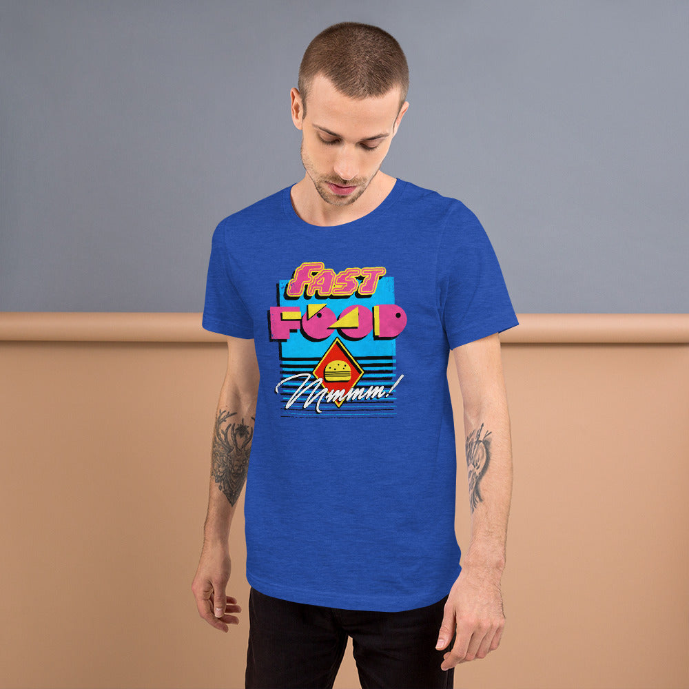 Tattooed man in a heather royal blue "Fast Food" neon graphic tee against a peach wall