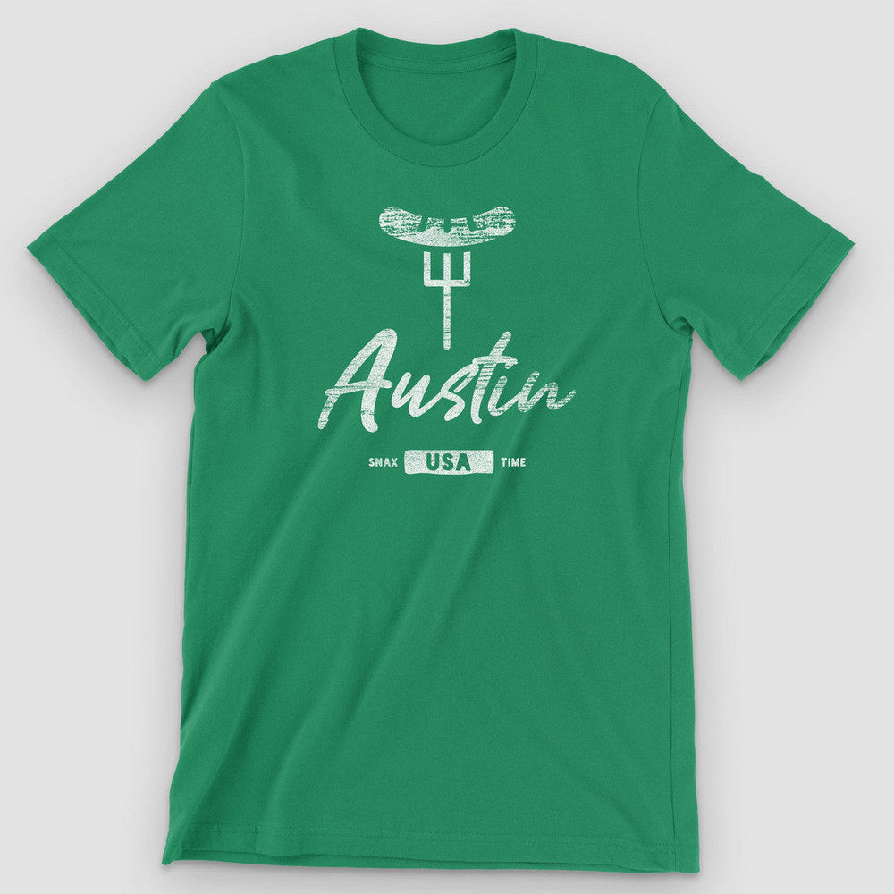 Kelly green t-shirt with a white barbecue-on-a-fork graphic and "Austin" brush script