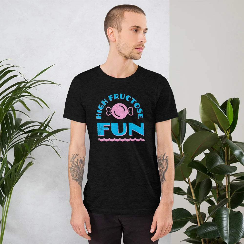 Person in a black heather HIGH FRUCTOSE FUN candy t-shirt standing between houseplants