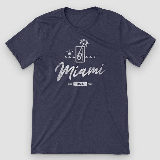 Heather navy t-shirt with a line-art cocktail glass, palm and sunset above Miami script