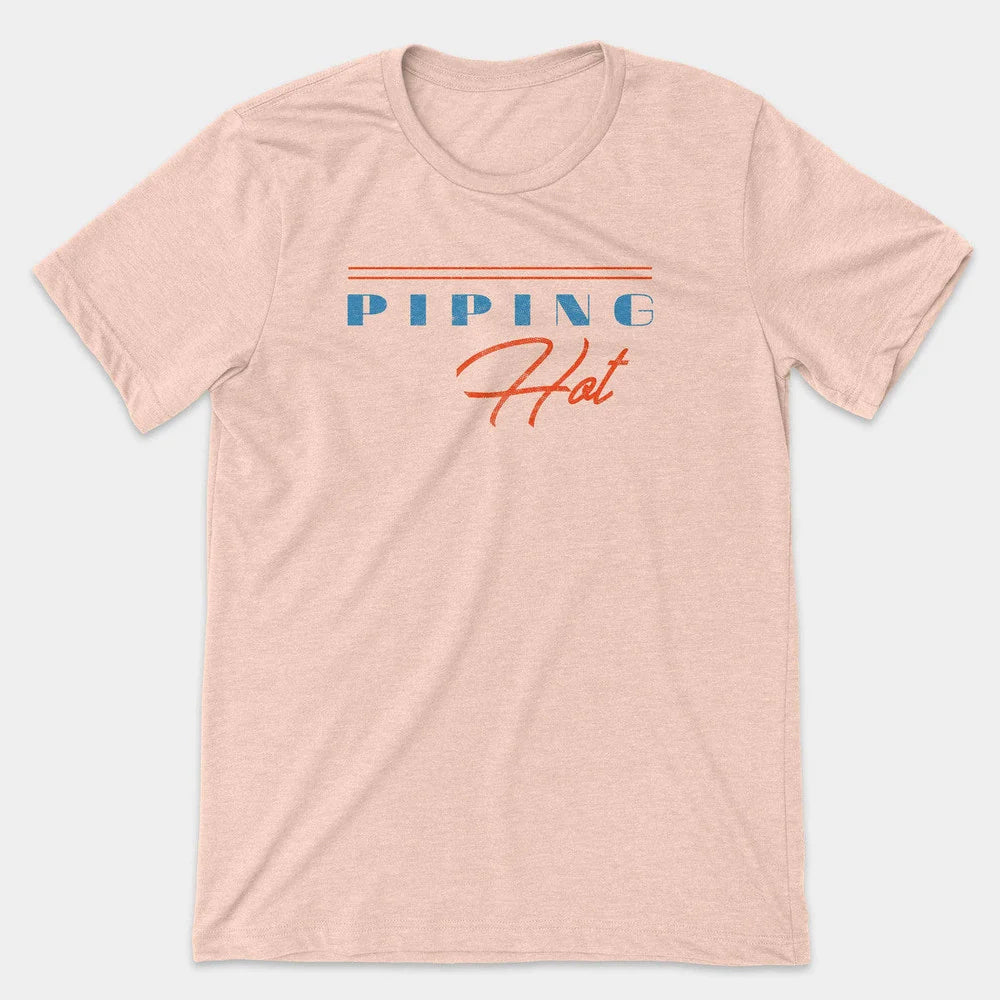 Pale peach t-shirt with retro blue "PIPING" lettering above orange "Hot" script and stripes