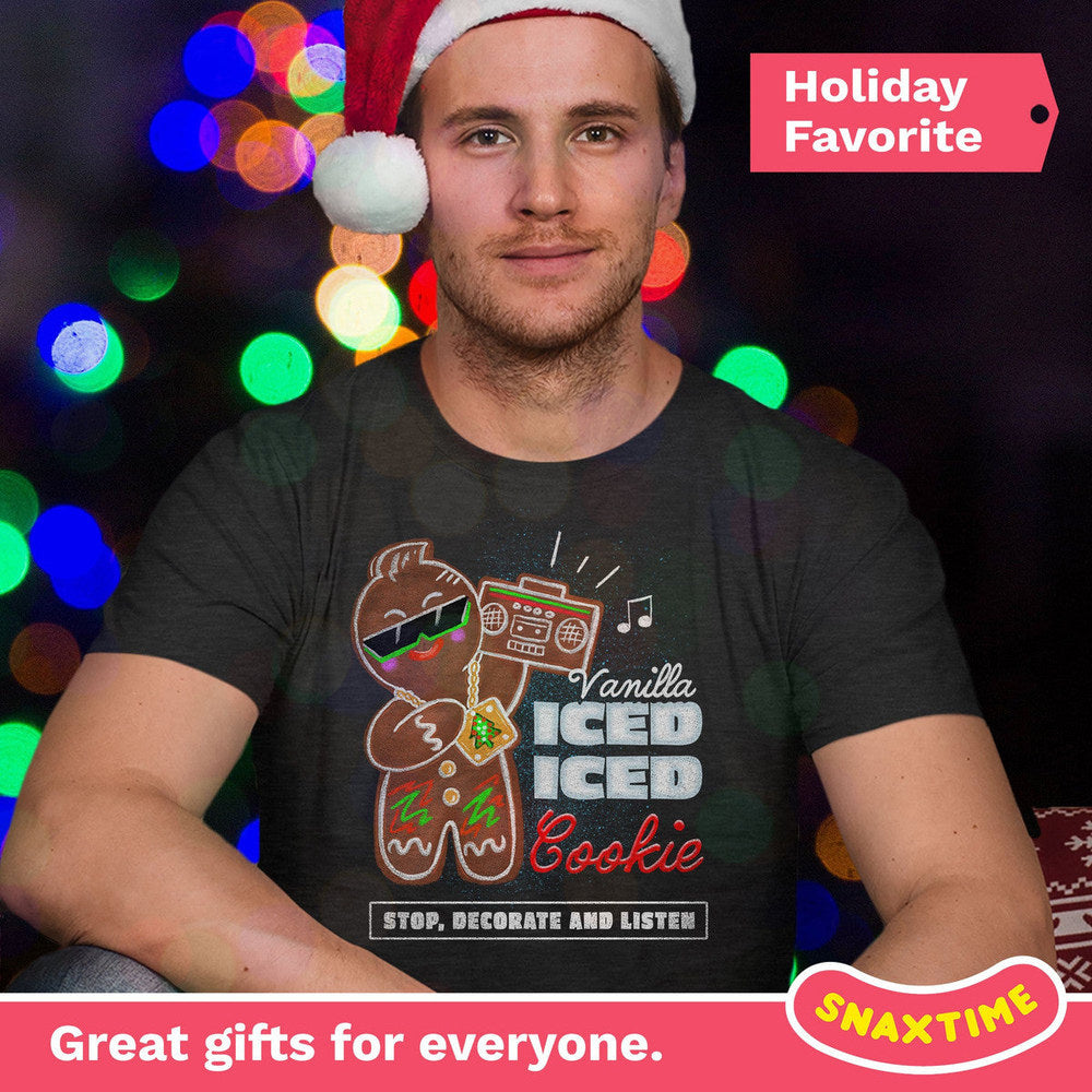 Person in a Santa hat wearing a dark gray gingerbread man rapper t-shirt against holiday lights